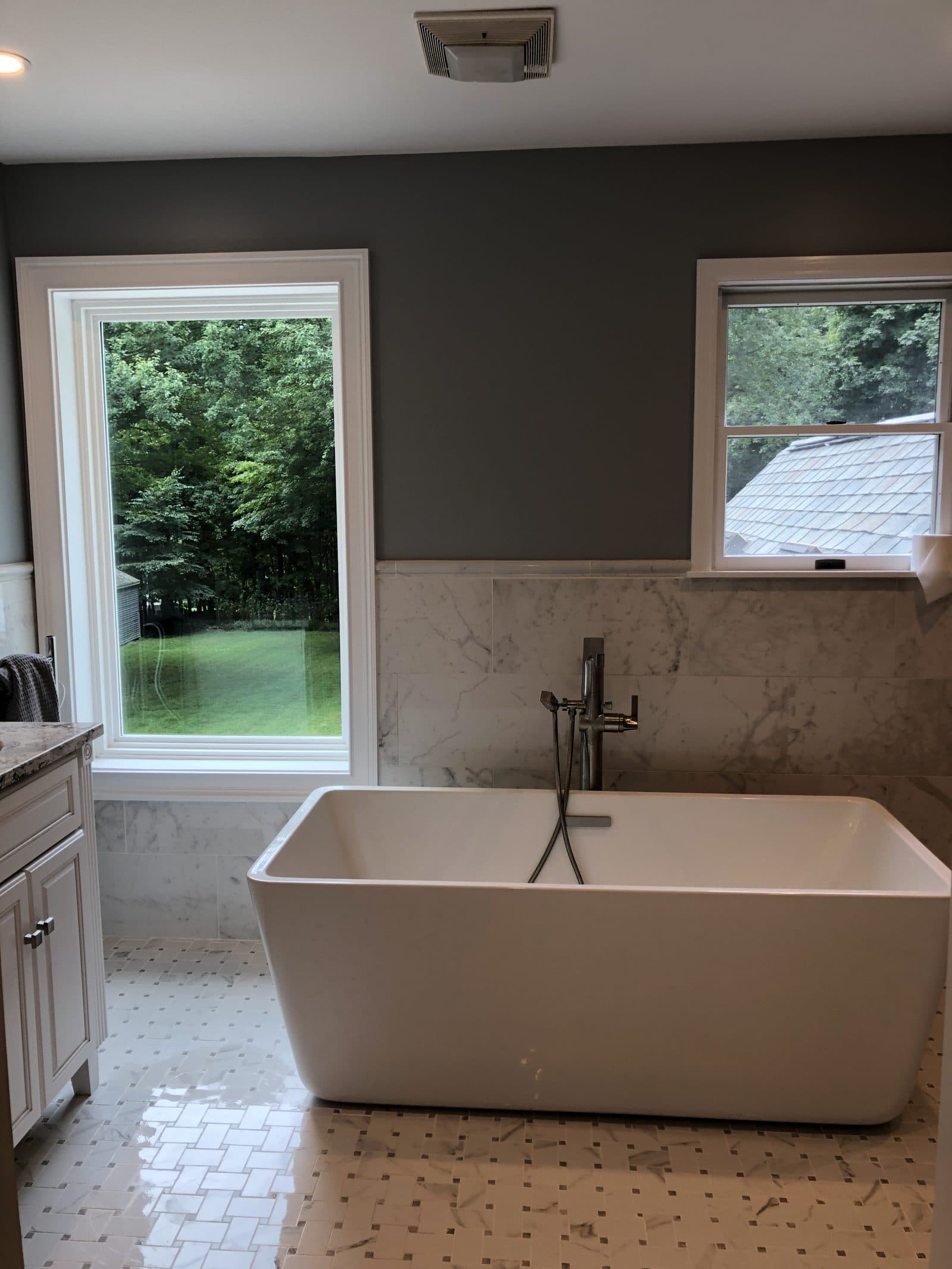 Bathroom with window and tiled shower