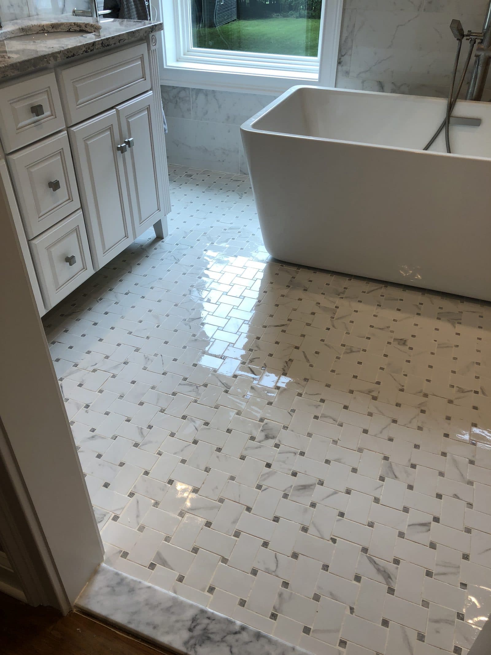 Bathroom vanity and tiled walls