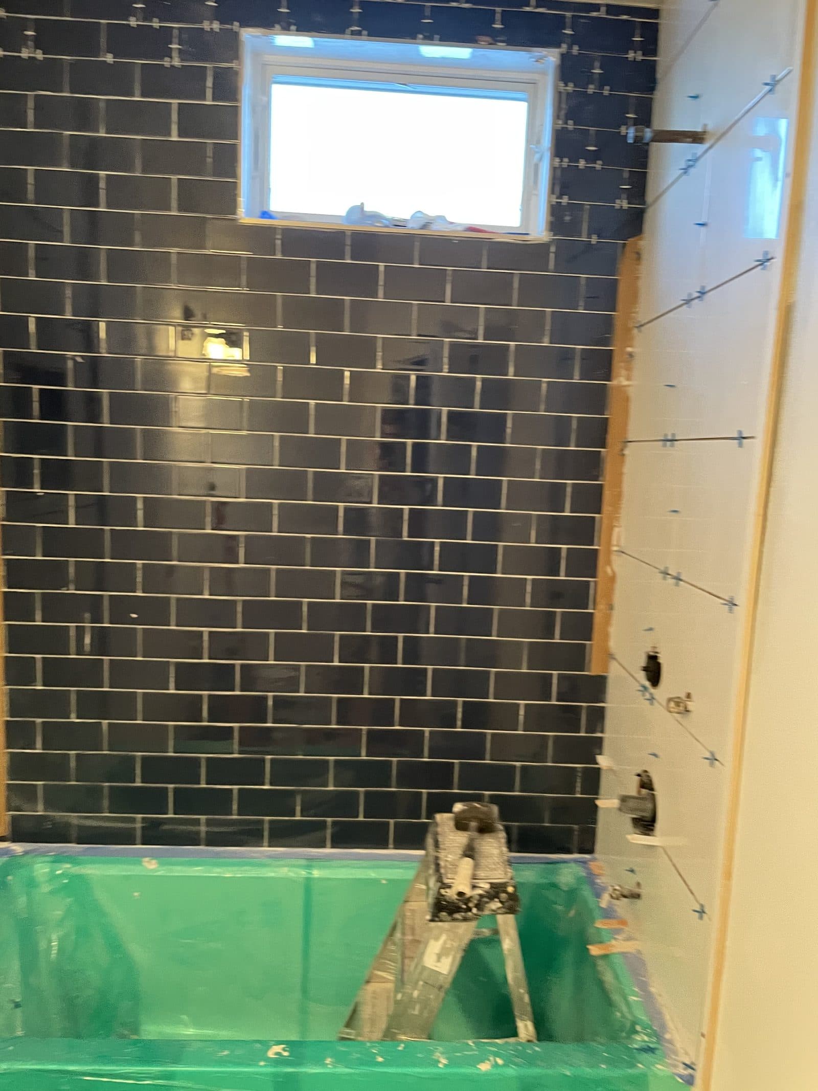 Blue-tiled bathroom under renovation