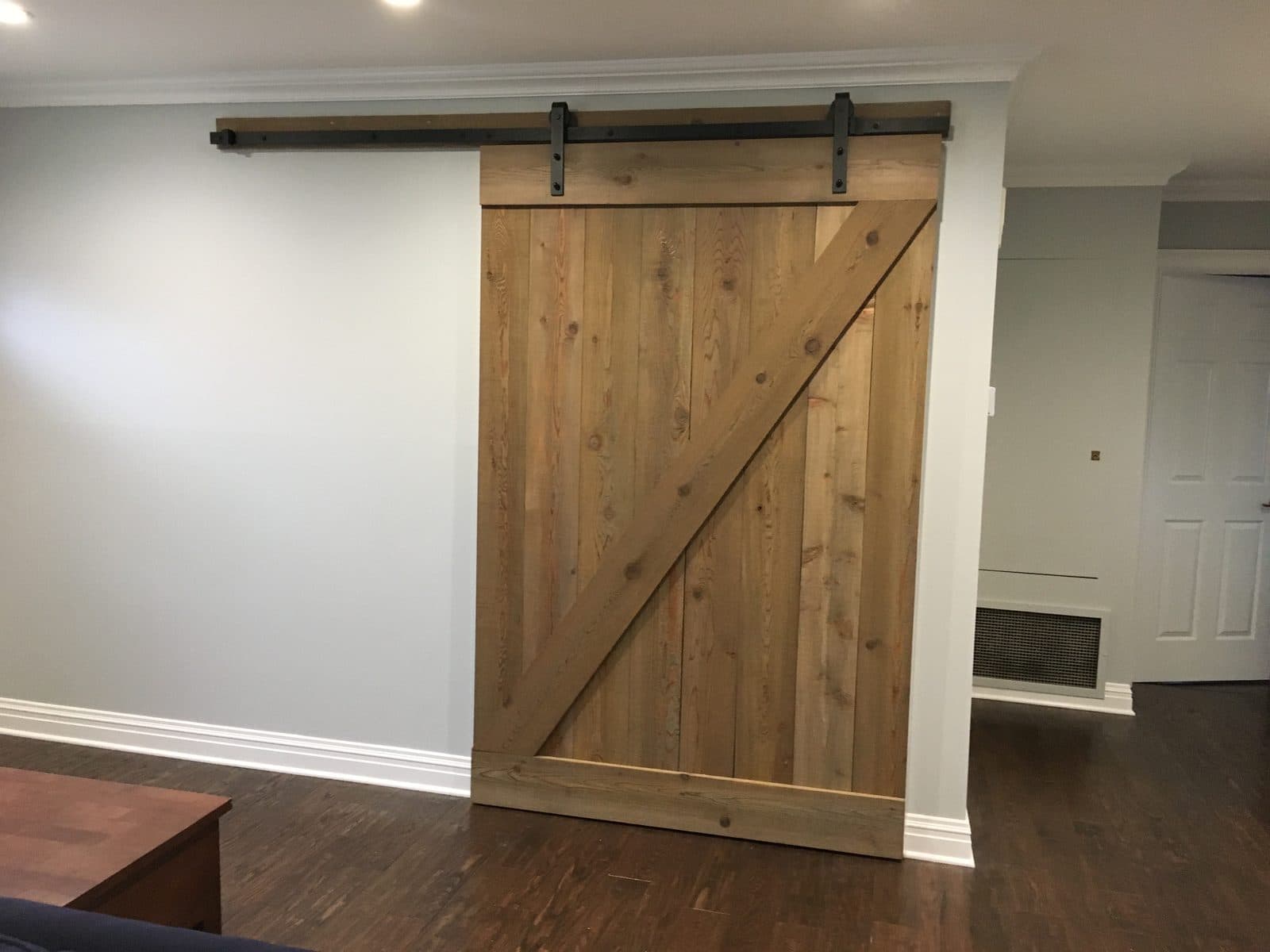 Barn door with wainscoting trim work