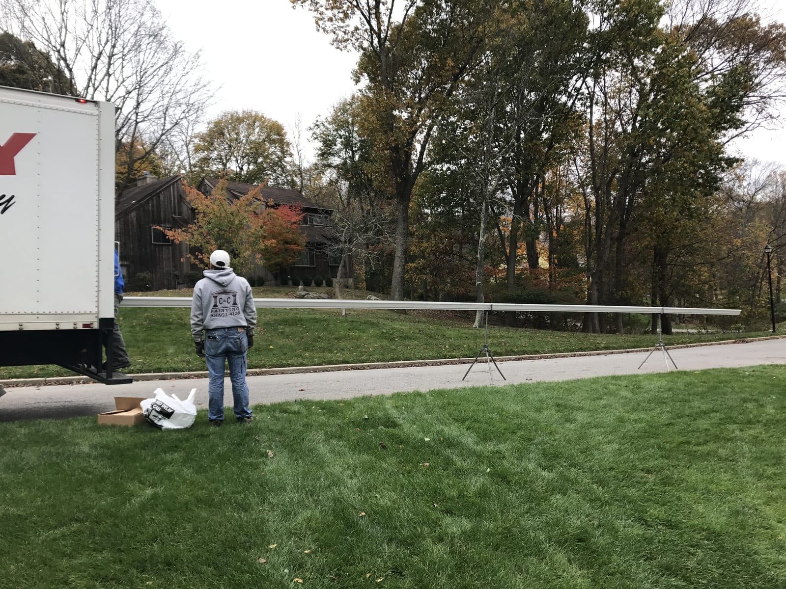 Crew member clearing a lawn during a seasonal property clean-up.