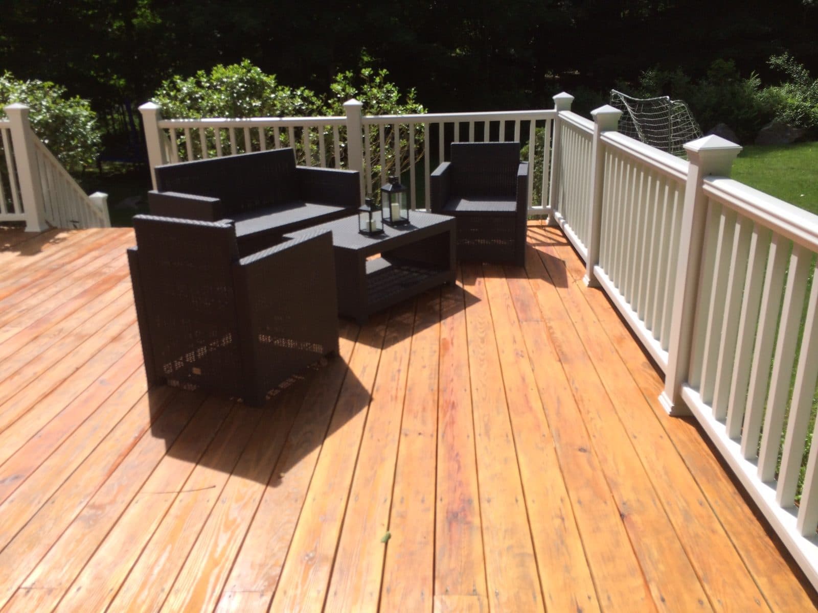 Freshly stained wood deck with outdoor furniture