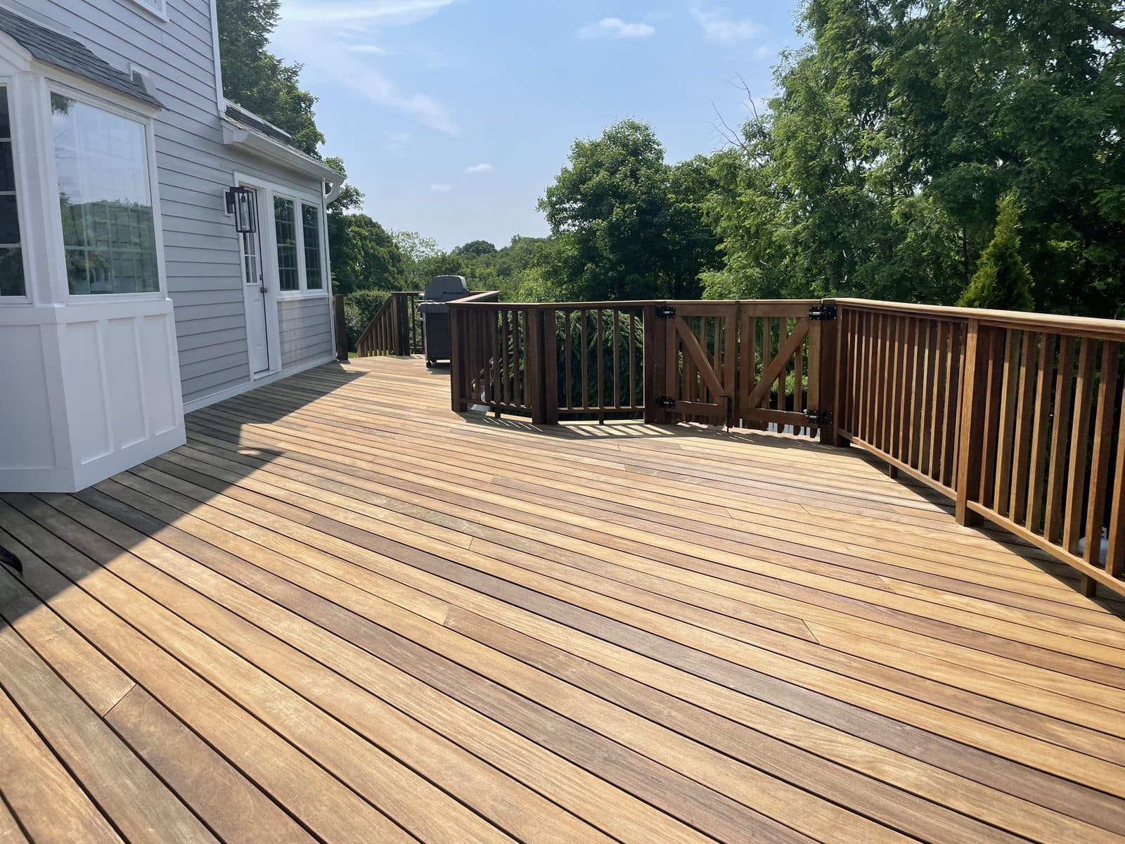 Freshly stained wood deck along house
