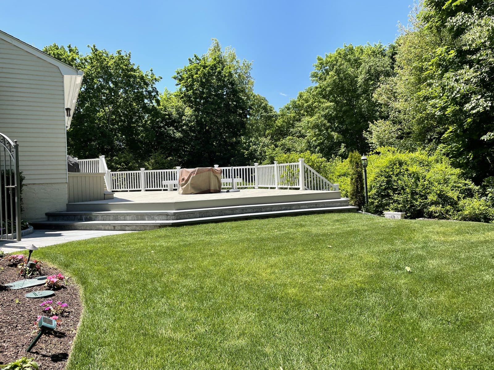 House with white fence and green lawn