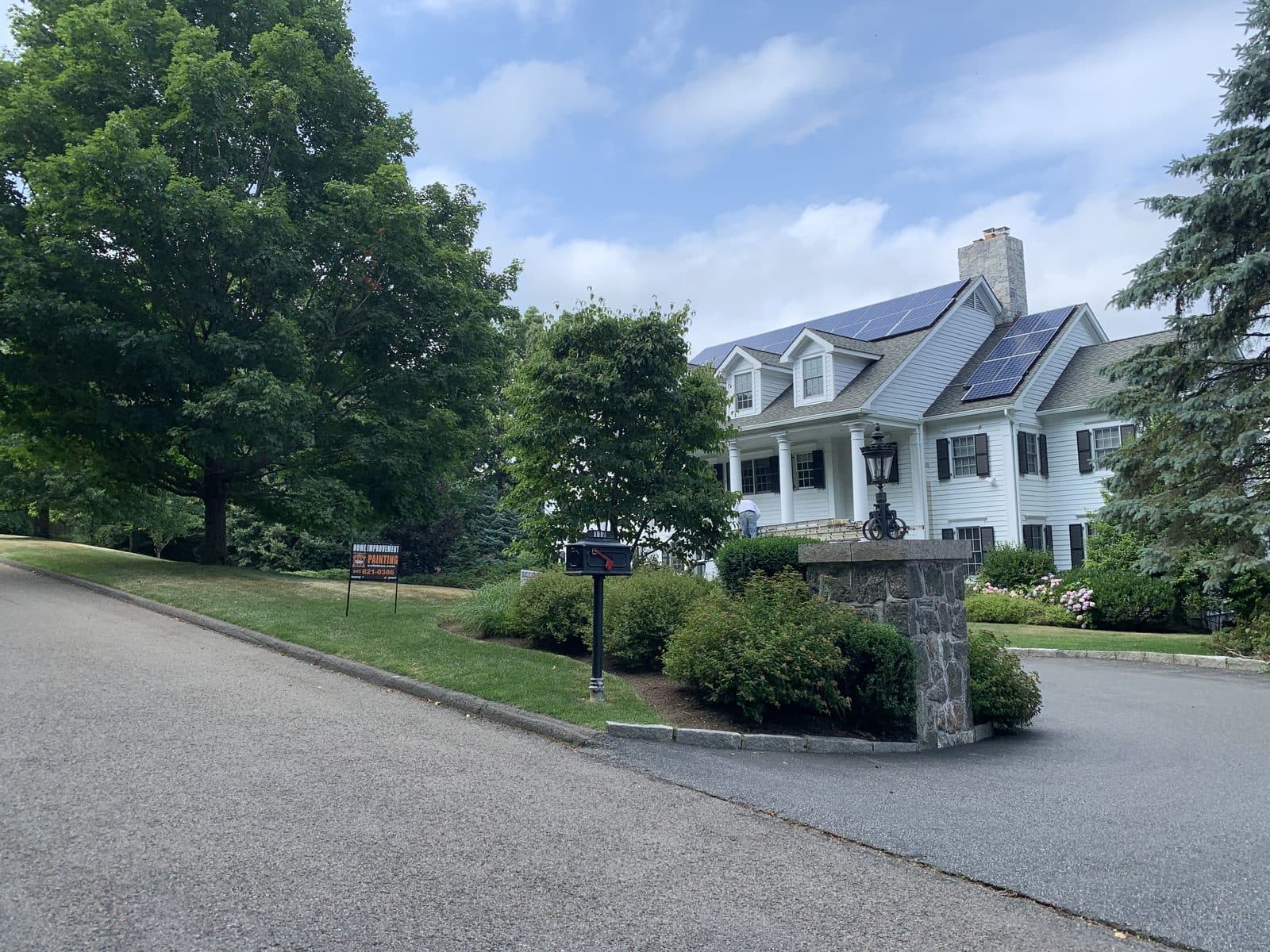 Large house with driveway and lawn