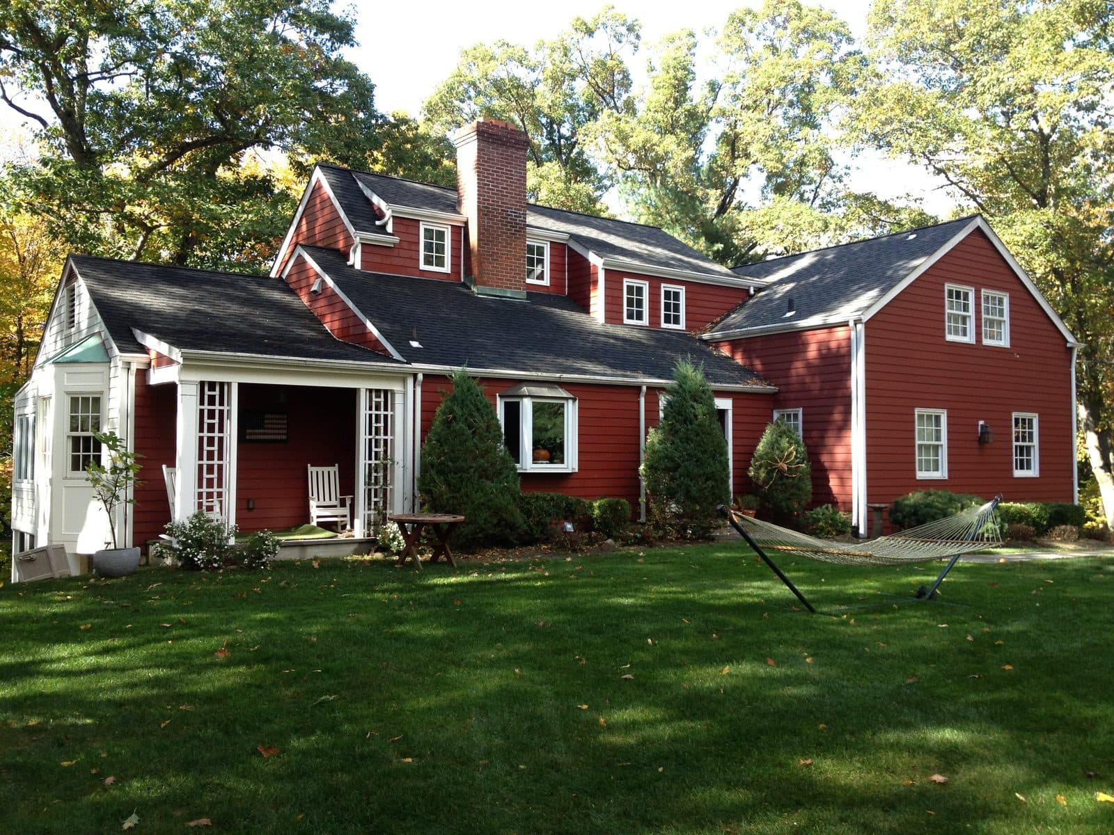Red colonial home with white trim