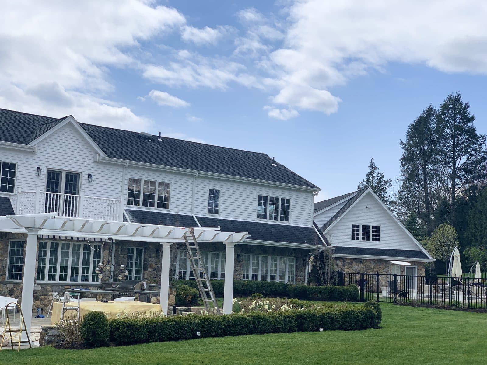 A large home with a manicured lawn improved by C&C Fabian.