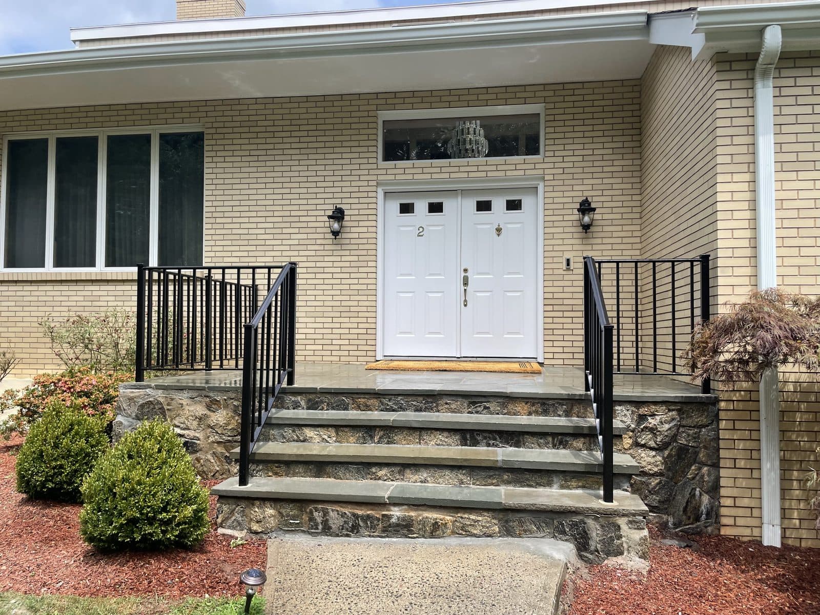 White brick home with columns entry