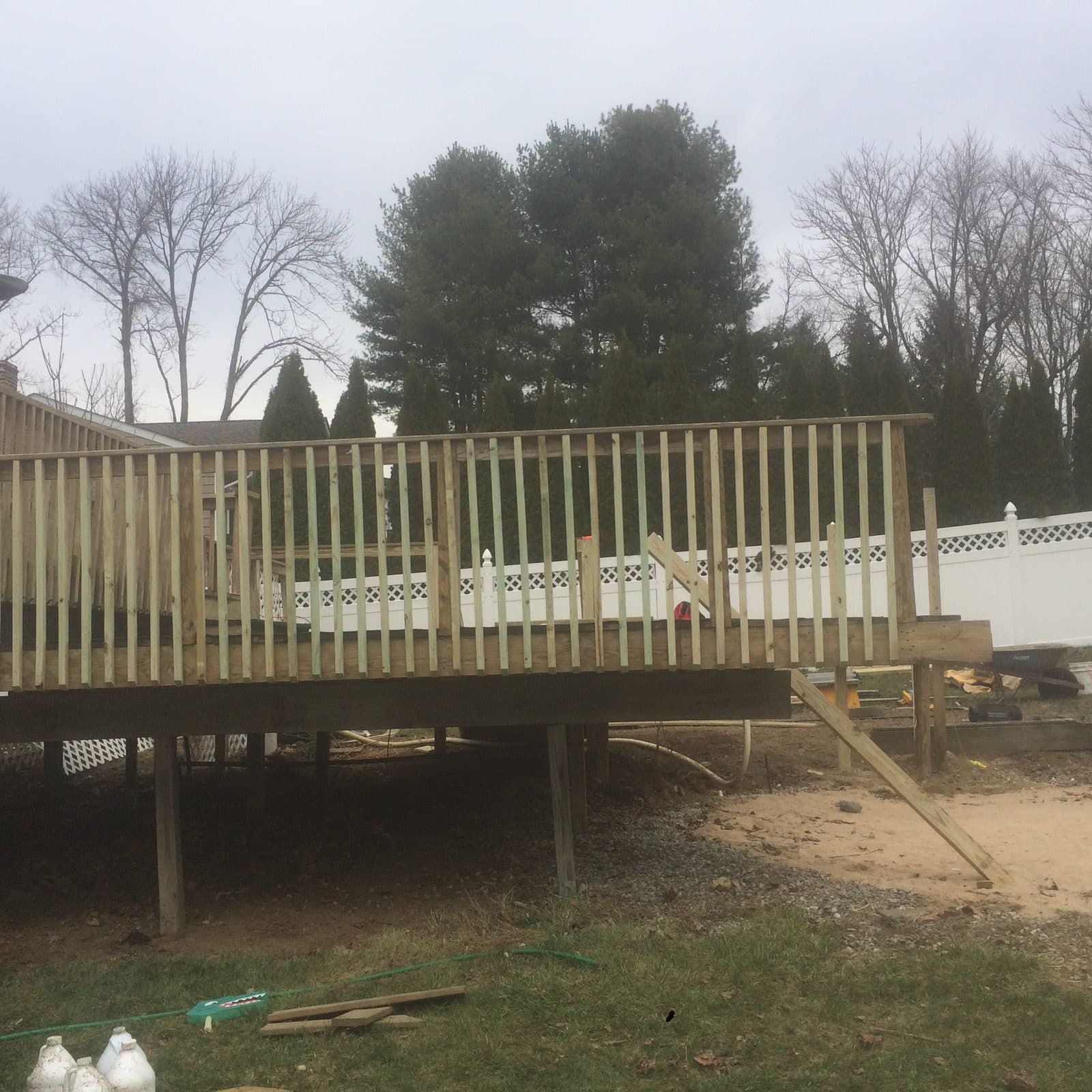 Wood fence along backyard tree line
