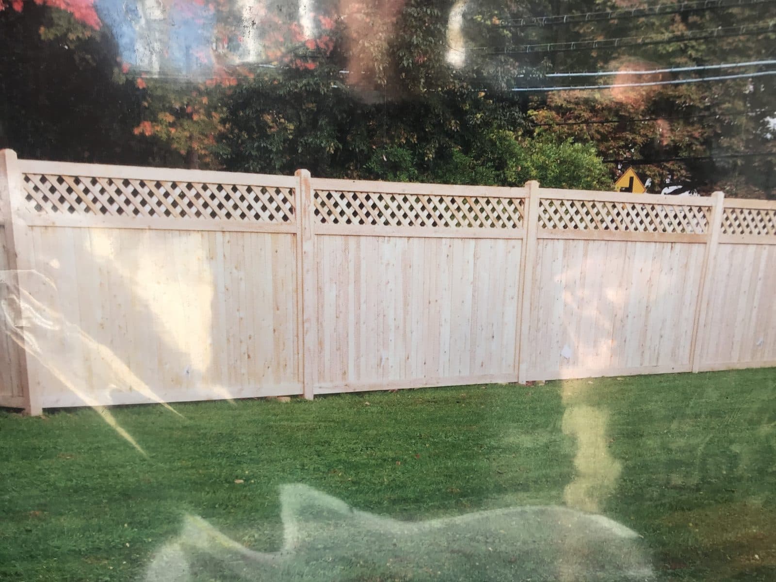 White vinyl privacy fence in yard
