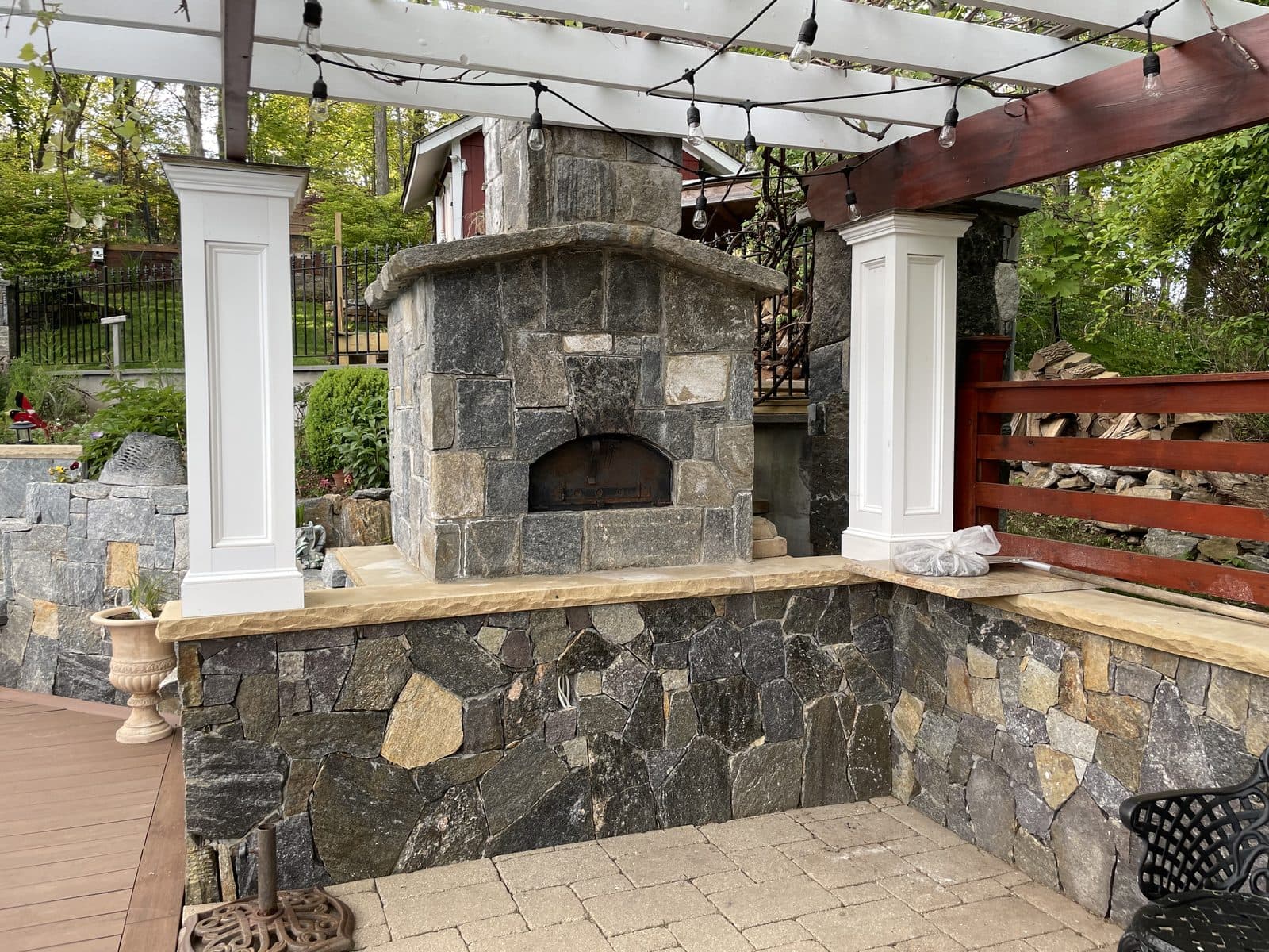 Stone outdoor fireplace and pergola masonry project