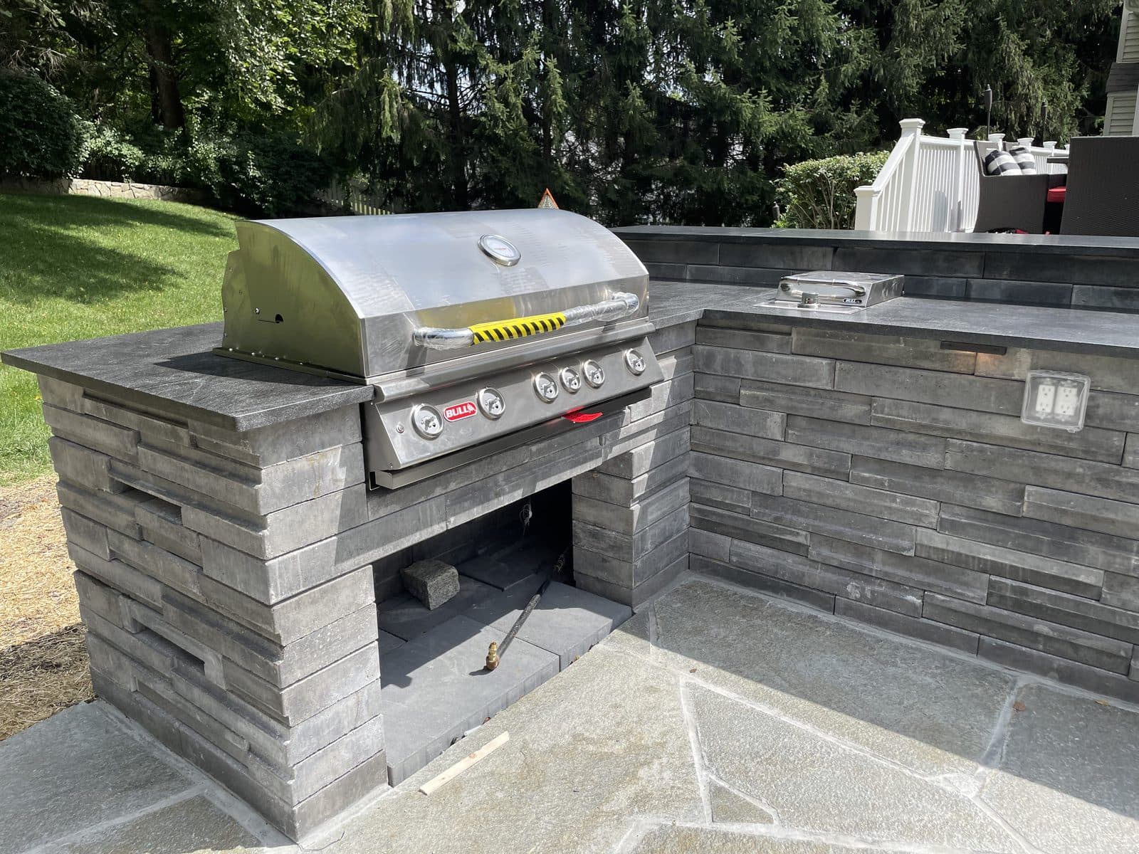 Stone outdoor kitchen grill island