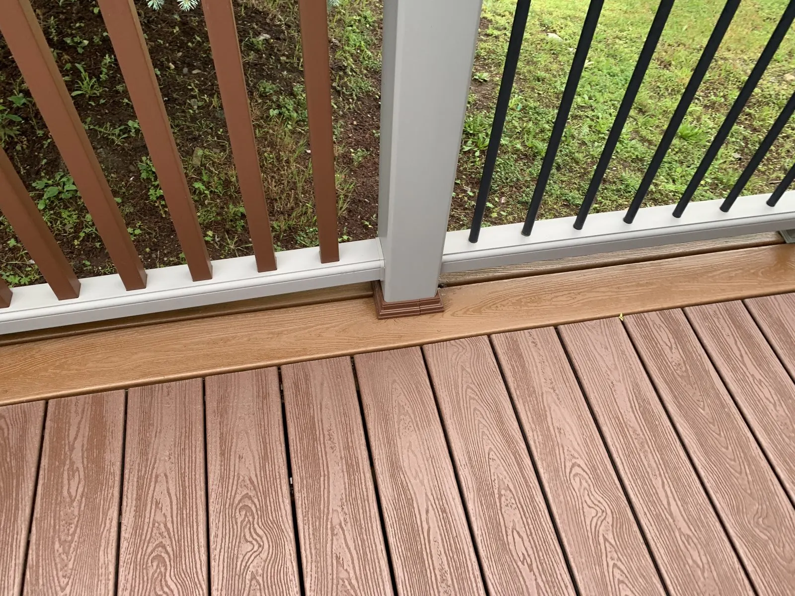 Stained wood deck with green lawn