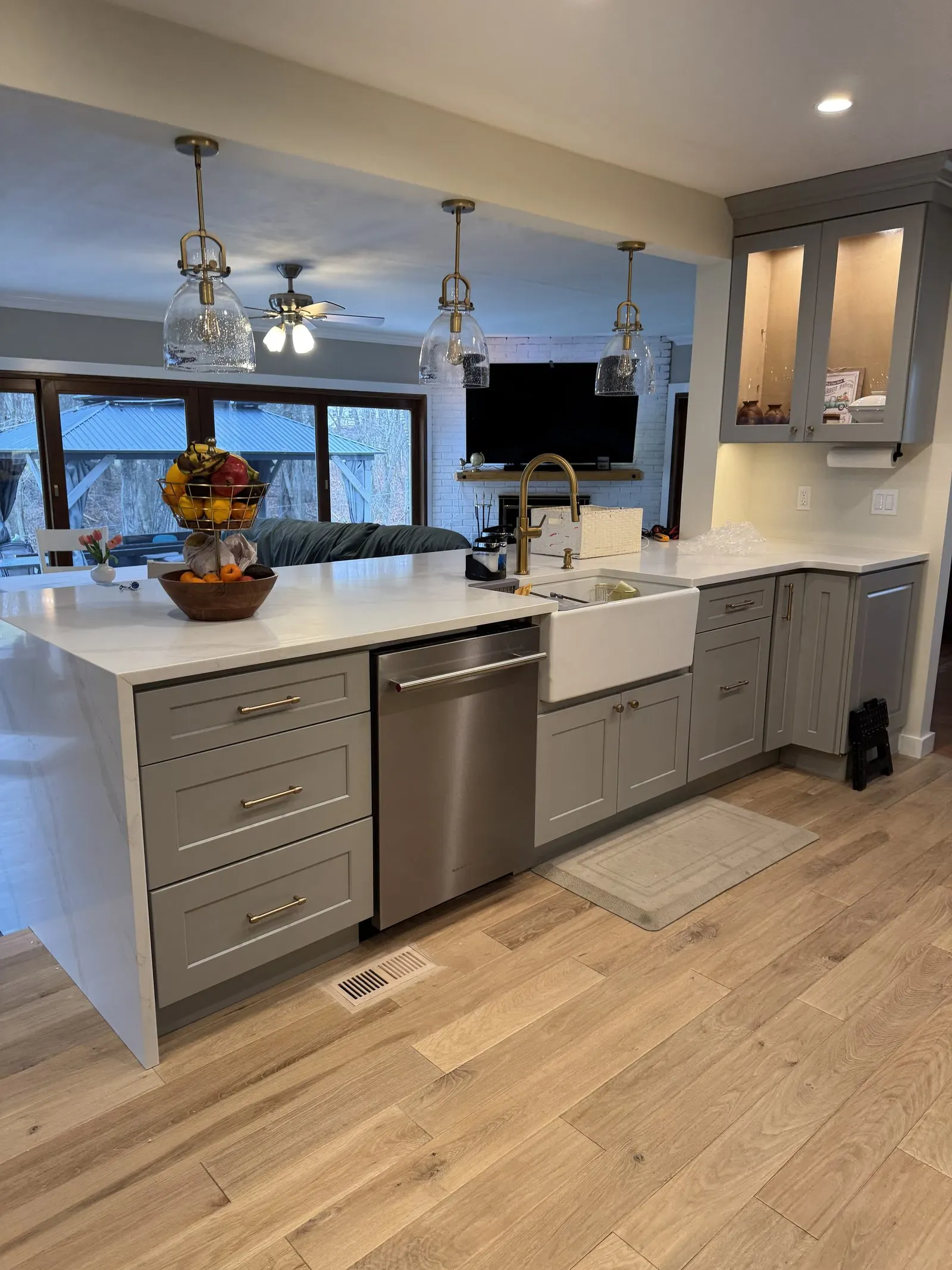 New kitchen island with a farmhouse sink and pendant lighting