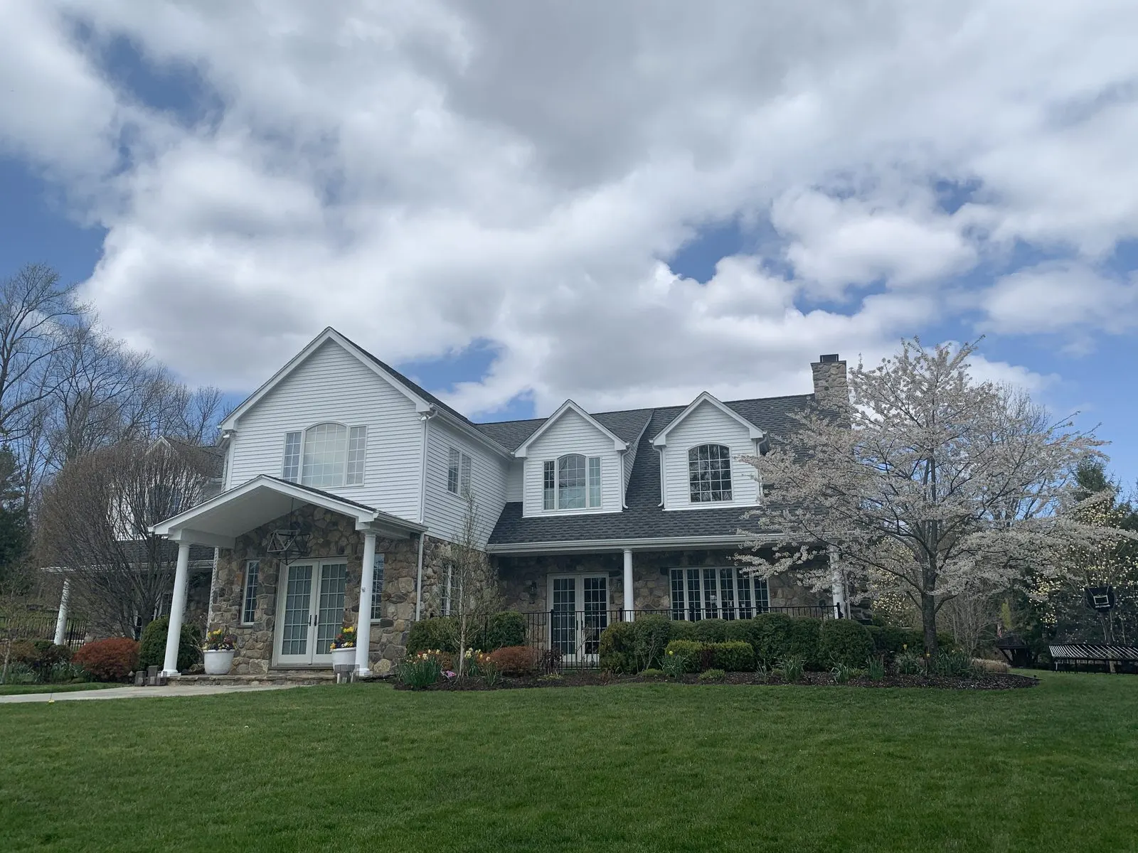 White colonial home with dormers