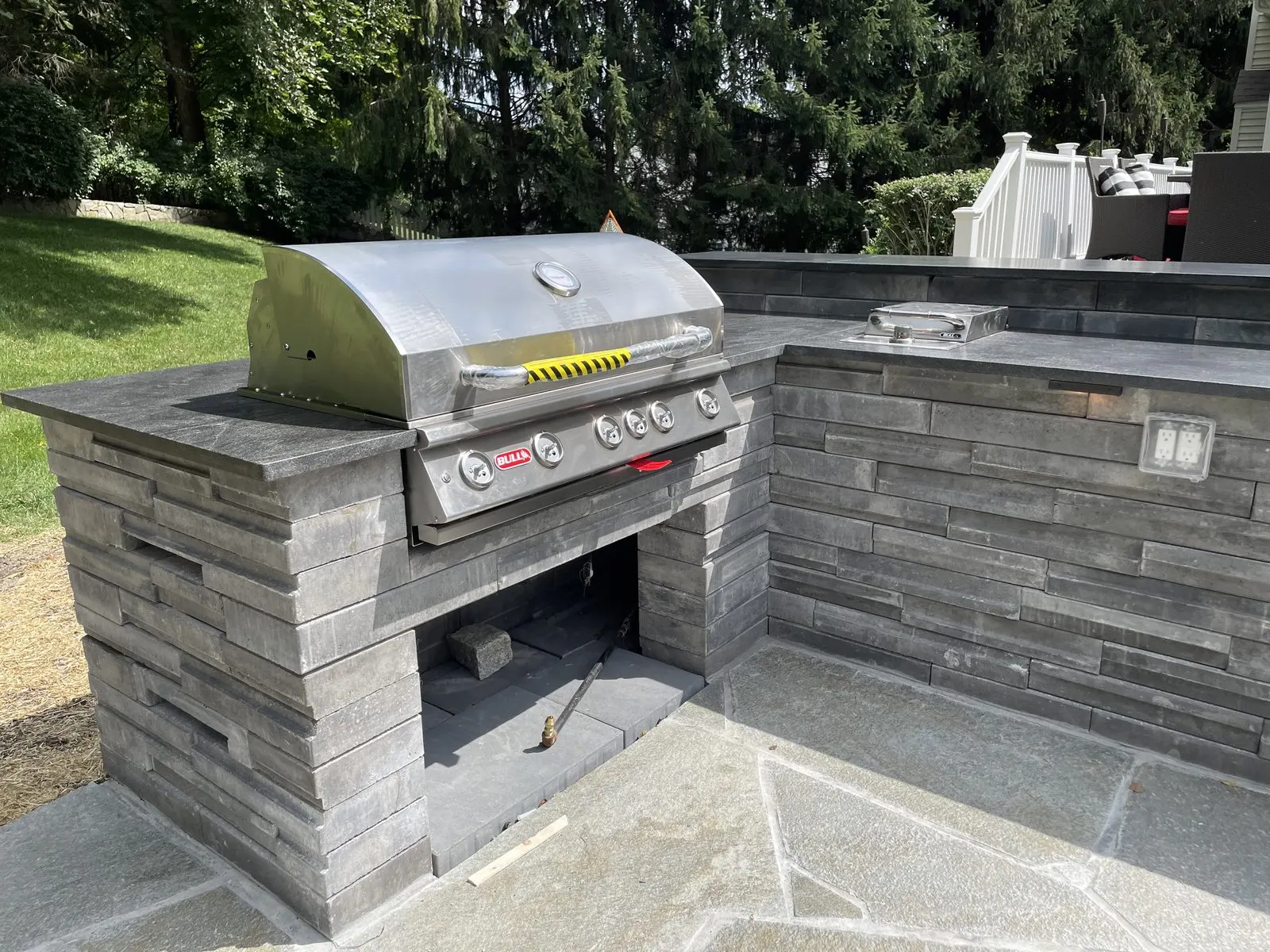 Stone outdoor kitchen grill island