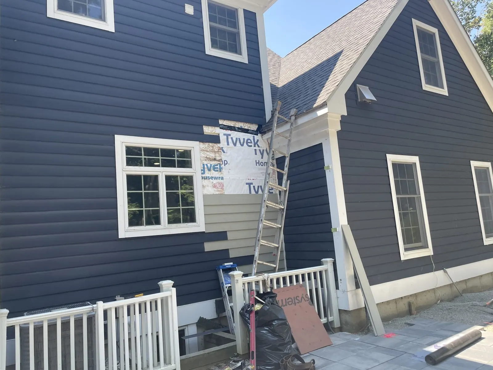 Dark blue sided house with white trim