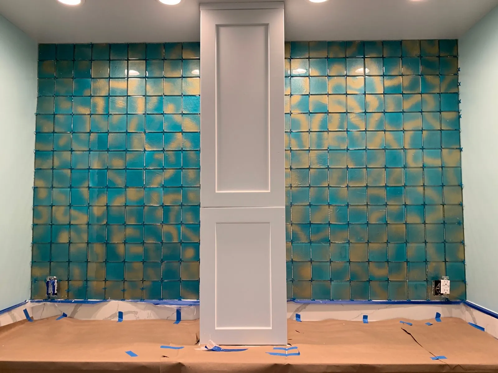 Freshly tiled feature wall and vanity in a remodeled bathroom