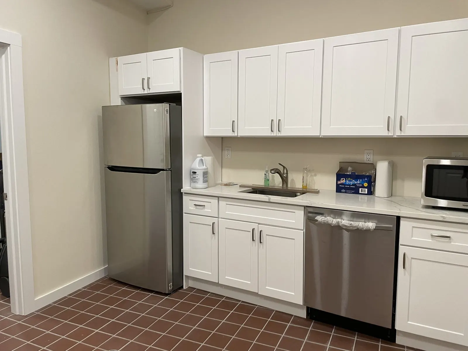 White kitchen with stainless appliances