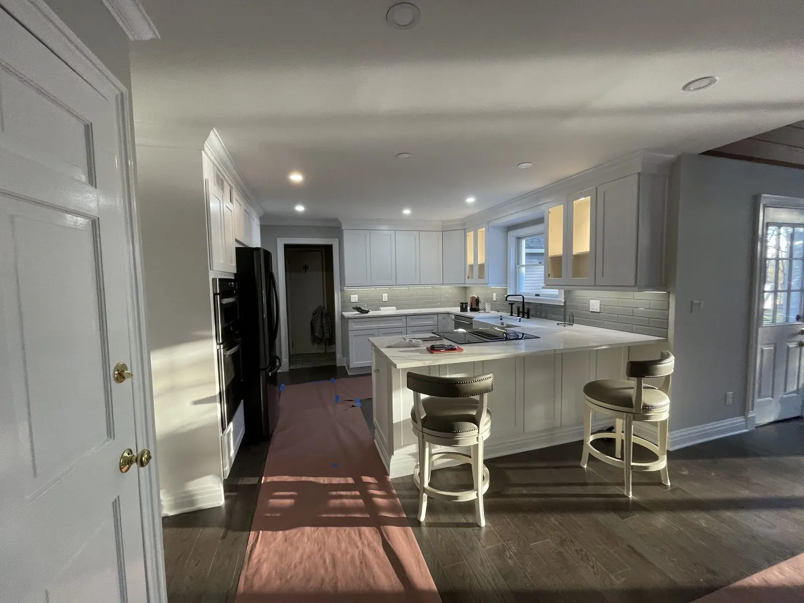White kitchen island with pendant lights