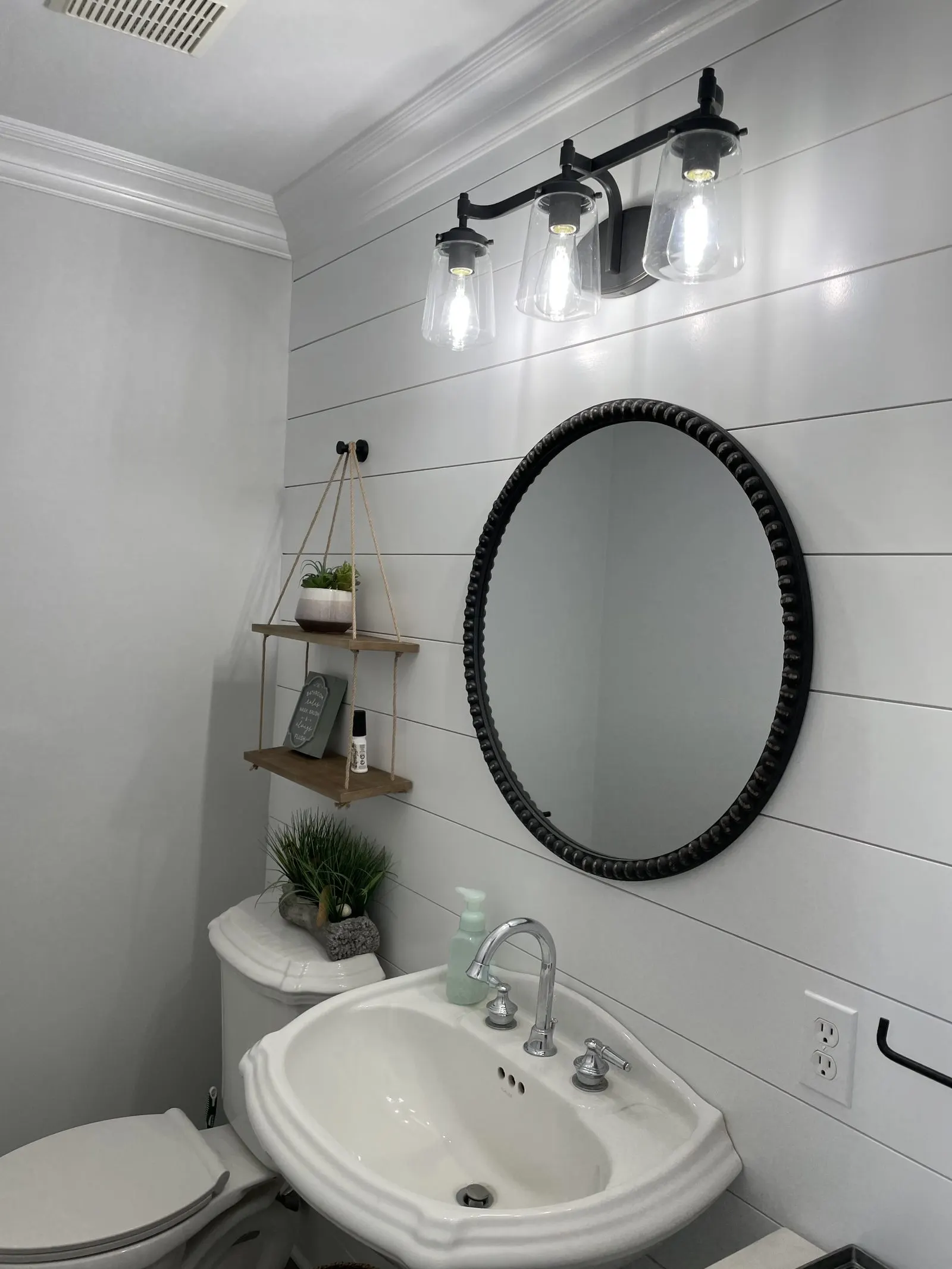 Modern bathroom with round mirror vanity