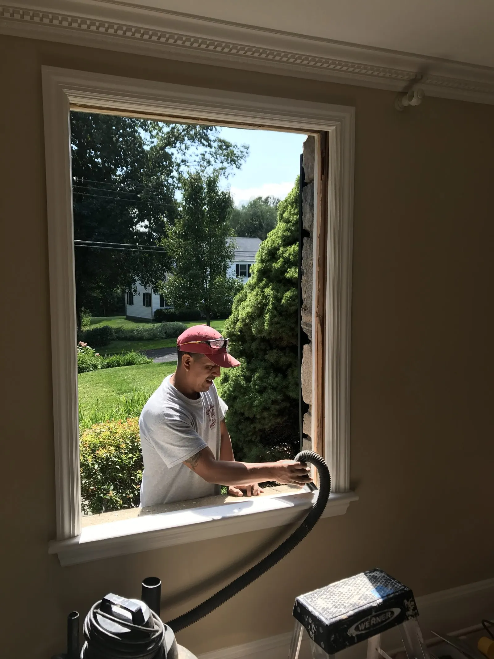 Carpenter installing a new window in a remodeled room