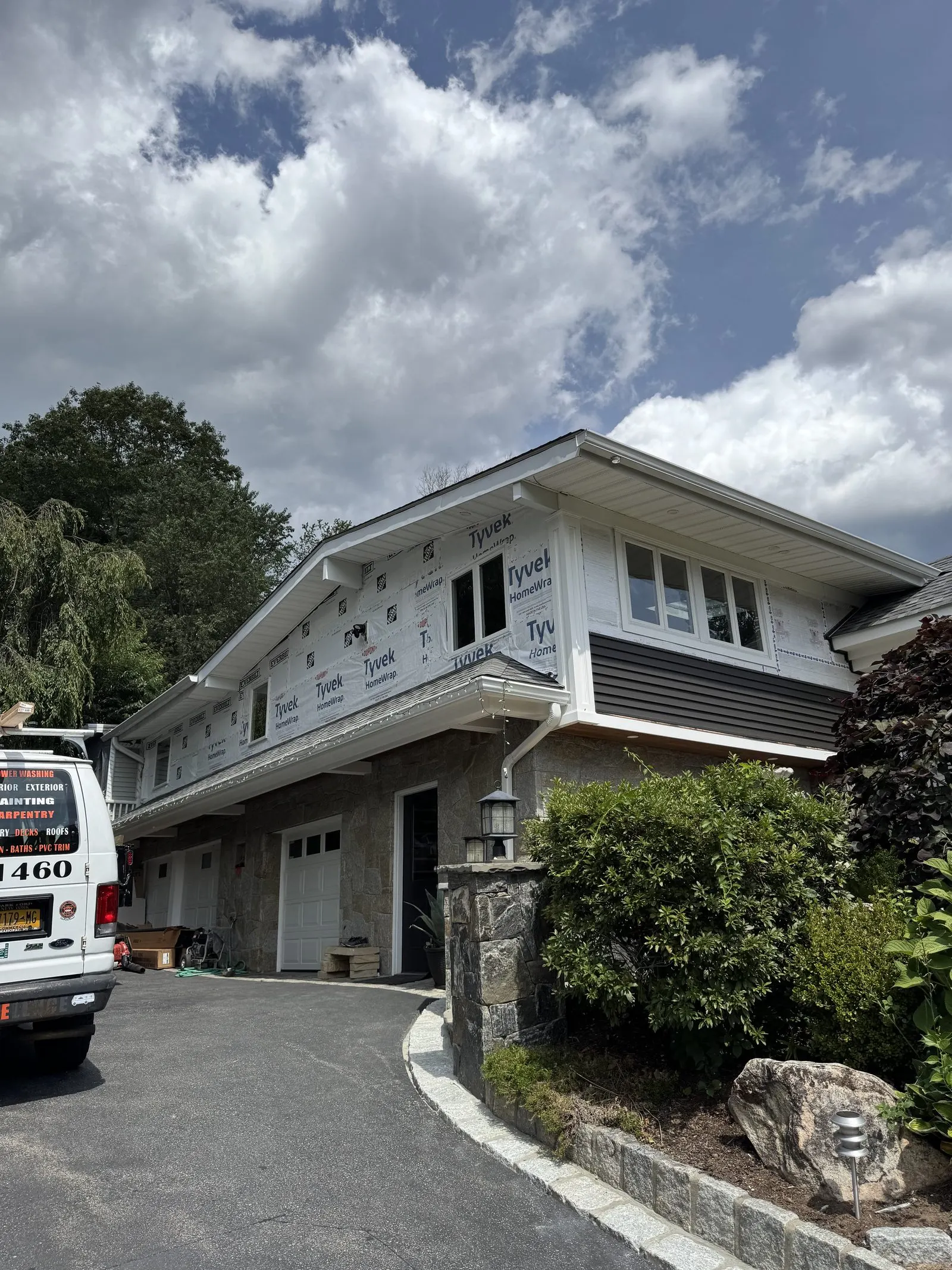 Modern gray split-level home after new siding installation