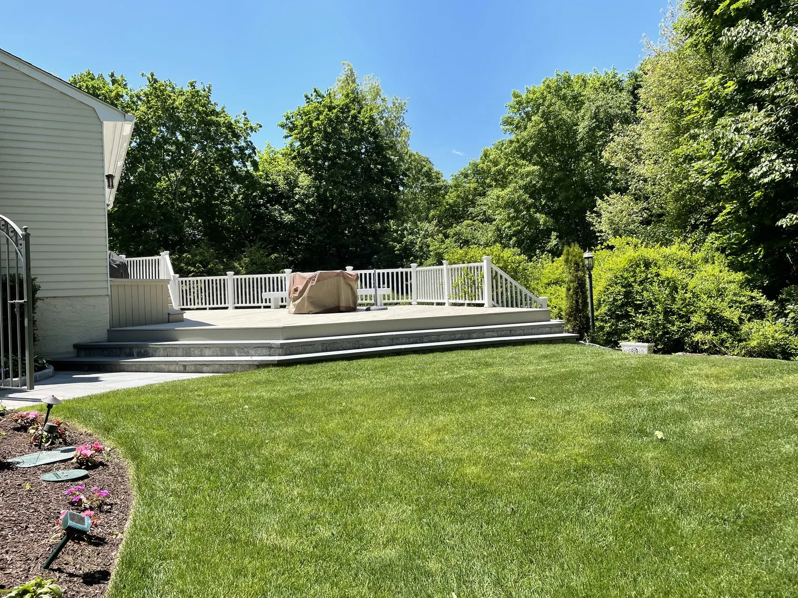 House with white fence and green lawn