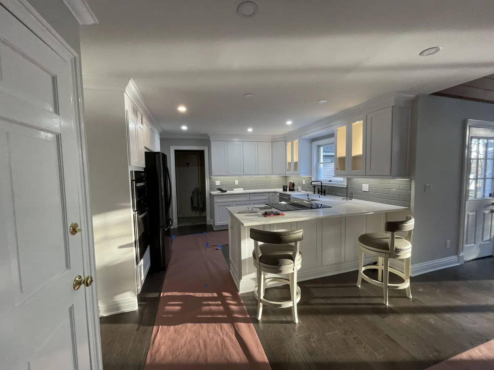 White kitchen island with pendant lights