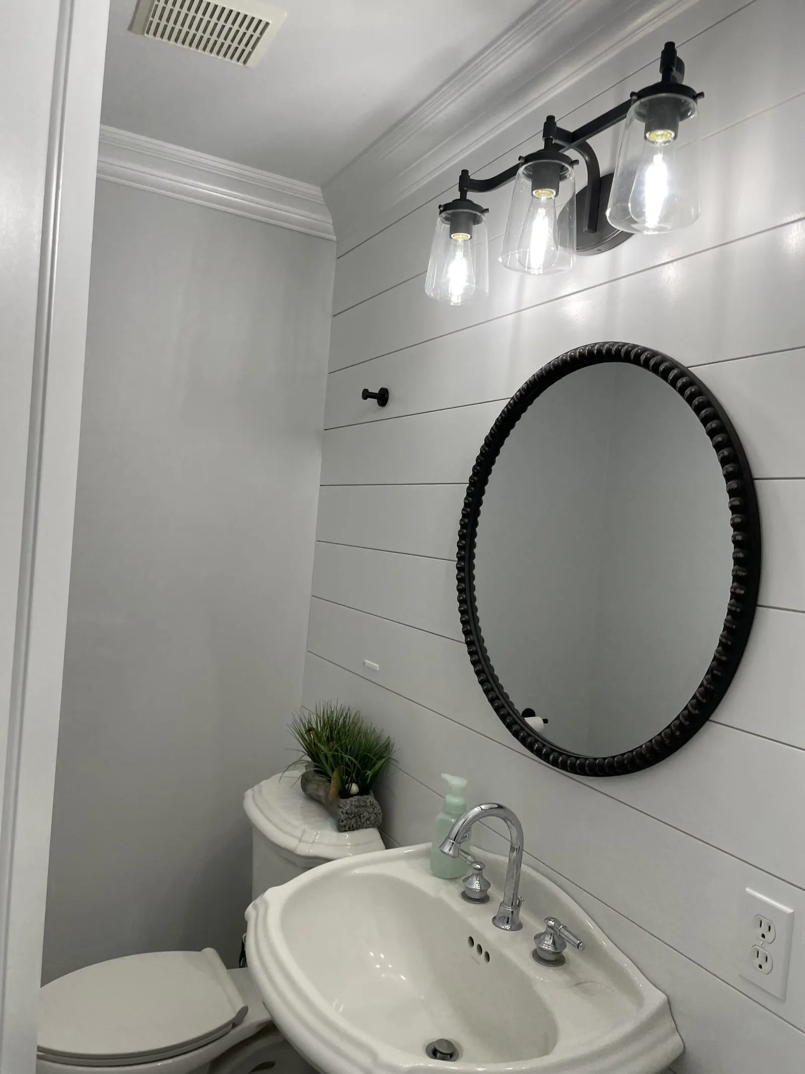White bathroom with round mirror vanity