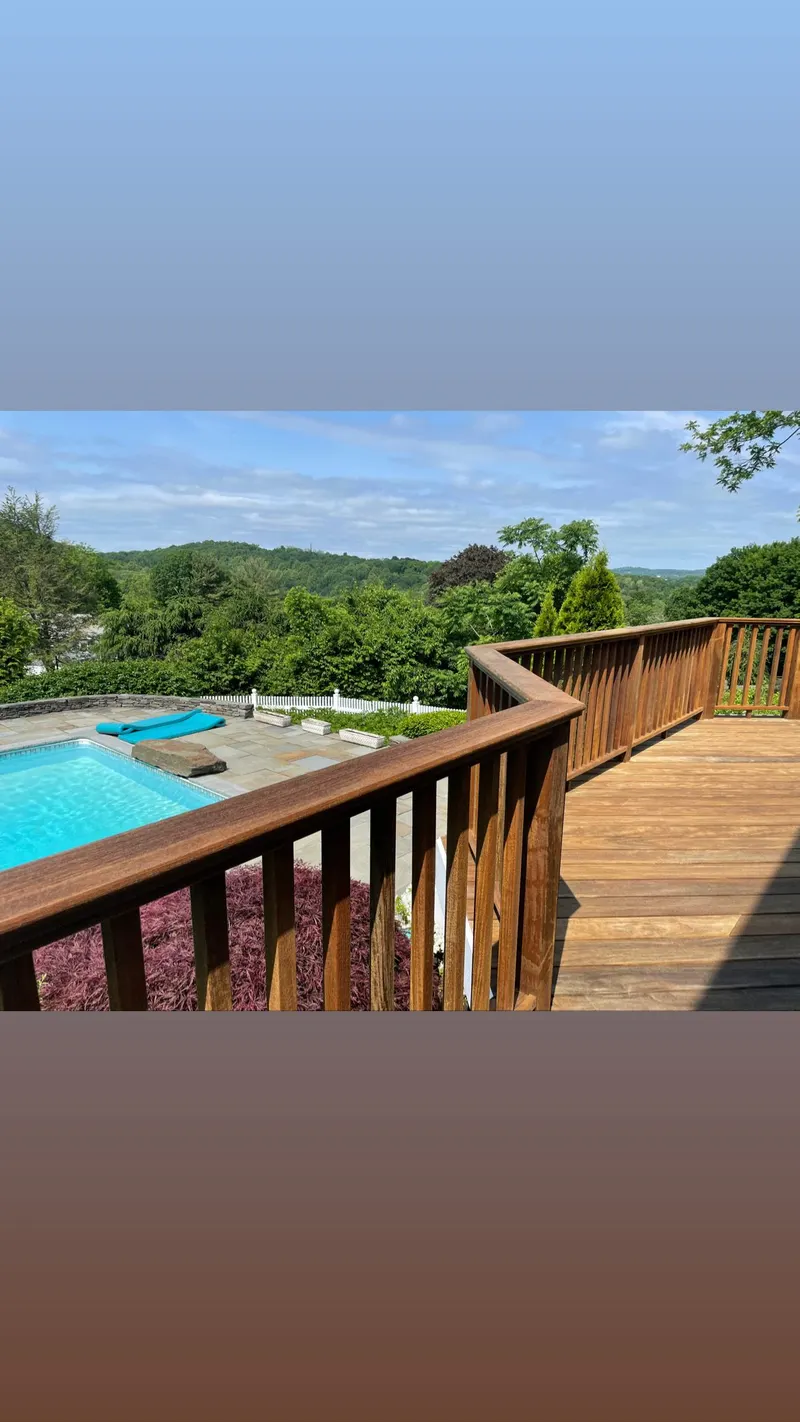 Wood deck overlooking pool and trees