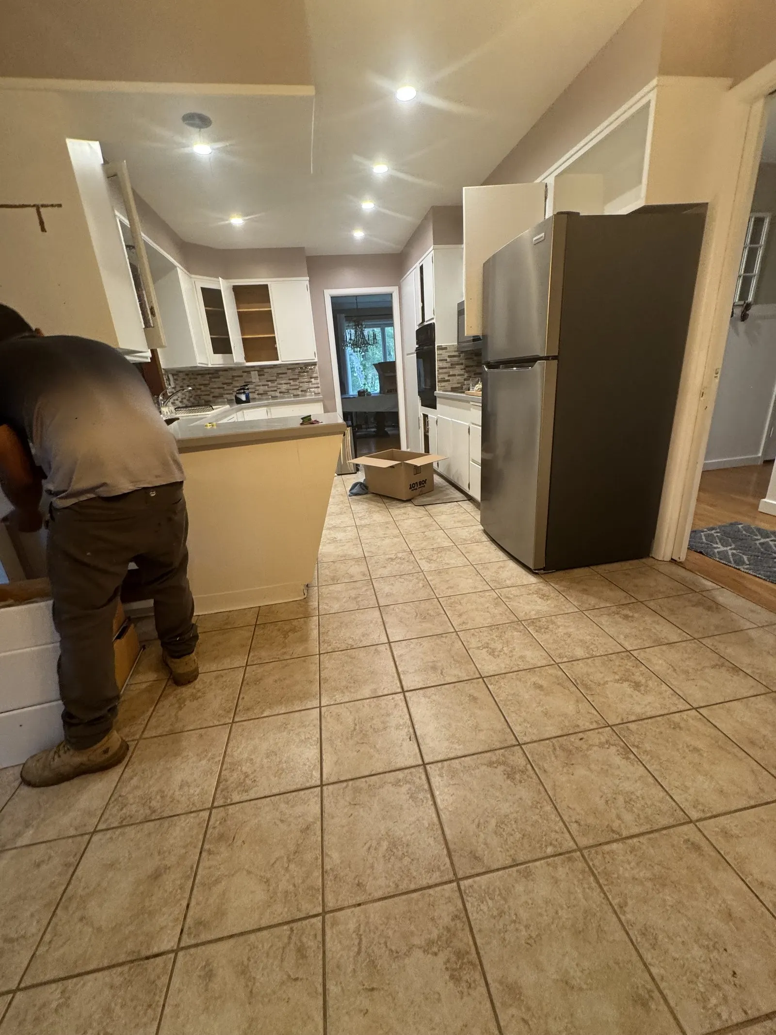 Dated kitchen with tan tile floor before renovation