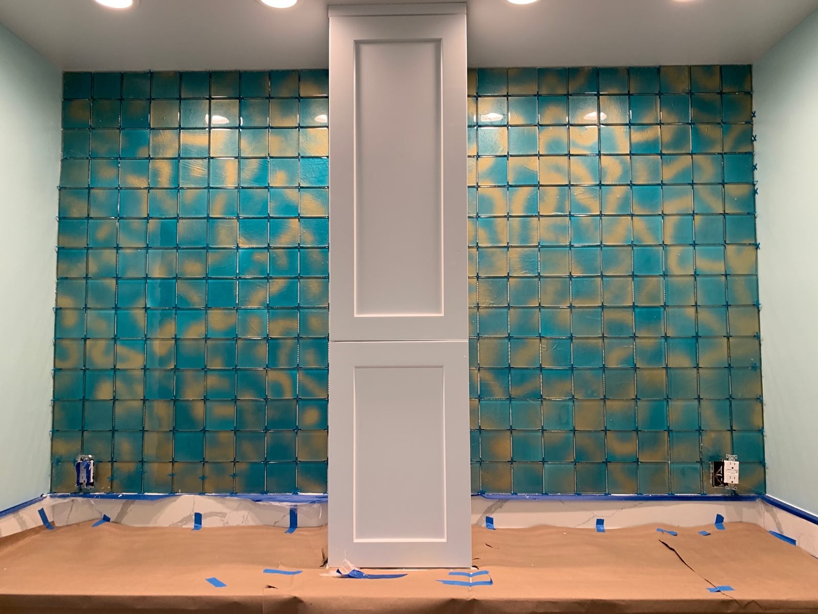 Freshly tiled feature wall and vanity in a remodeled bathroom
