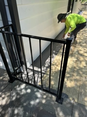 Crew member installing a metal stair railing