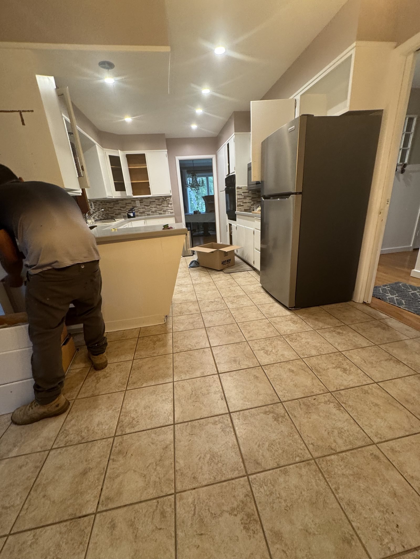 Dated kitchen with tan tile floor before renovation